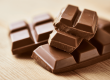 Blokjes melkchocolade op een houten tafel
